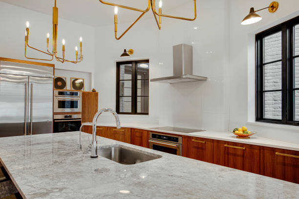 Contemporary Kitchen With Marble Island And Gold Fixtures.