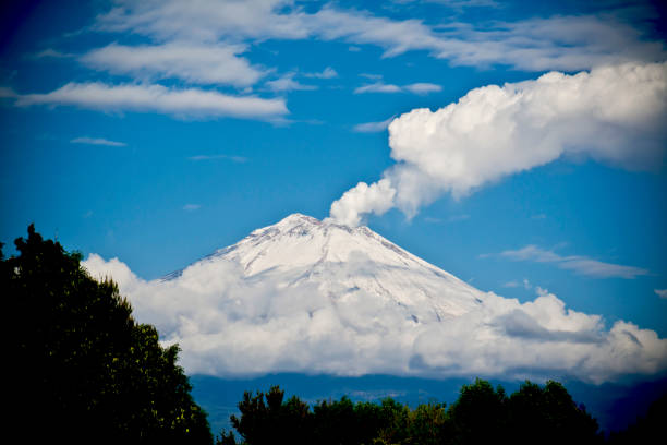Mexican volcano Popocatepetl on a cloudy landscape at Puebla, Mexico.