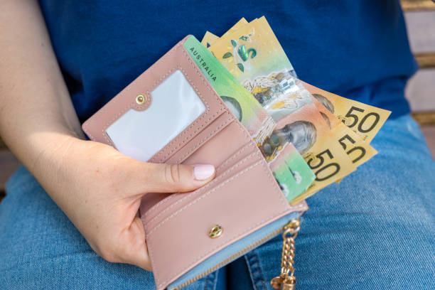 istock woman holding Australian dollars with wallet. Aud financing concept 2178755614