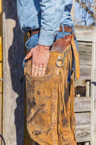 istock Cowboy wearing leather chaps and blue jeans. 2178757515