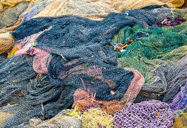 Heap of buoys and fishing net on harbor dock. Selective focus. Pontevedra province, Galicia, Spain.