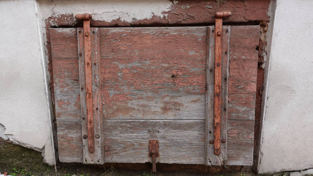 istock Rustic Wooden Cellar Door With Rusty Hinges in Countryside Building 2178766031