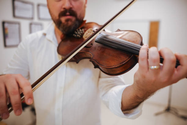 istock Unrecognizable men playing violin at home 2178767488