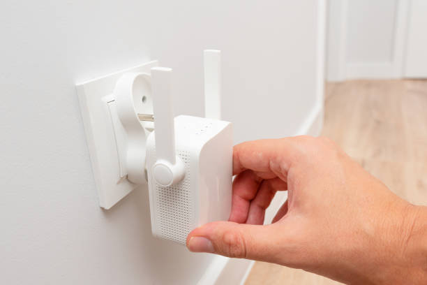 istock Wireless Wi-Fi repeater on white wall indoors 2178768269