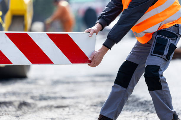 istock Worker placing a safety barrier on a construction site during the daytime to manage traffic flow and ensure safety 2178770272