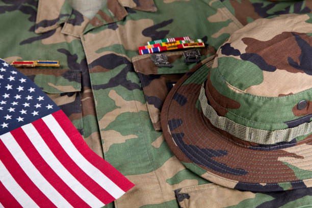 istock American solders camouflage hat, jacket and American Flag 2178771657