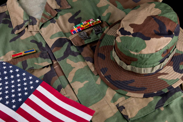 istock American solders camouflage hat and jacket with American Flag 2178771672