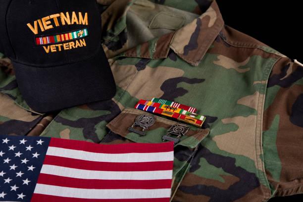 istock Vietnam veterans decorations, camouflage jacket, cap and American Flag 2178771789