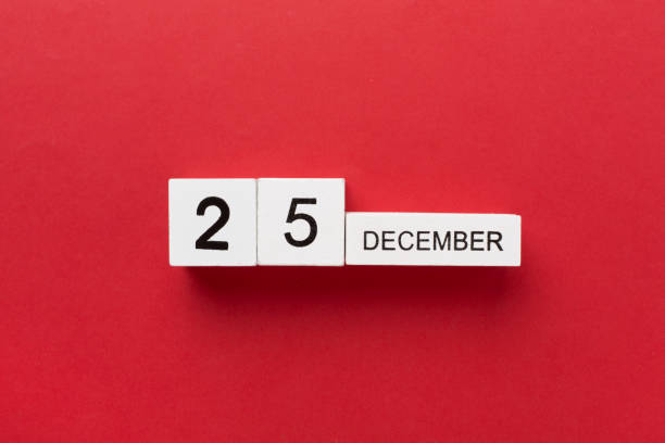 Calendar with date December 25 on color background, top view
