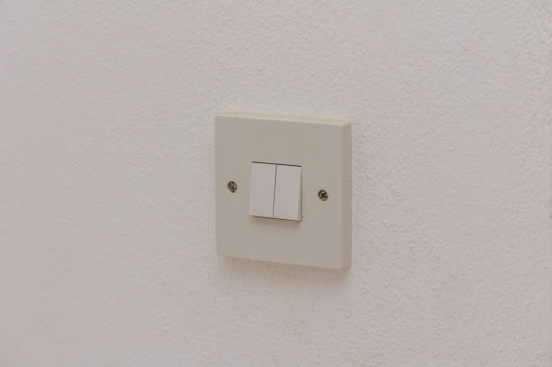 istock A Simple Light Switch on a White Wall Providing Illumination in a Minimalist Room Setting During Daytime Hours 2178774815