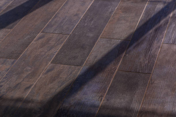 istock Warm Sunlight Filters Through, Casting Intricate Shadows on a Rustic Wooden Floor in a Tranquil Indoor Space 2178774827