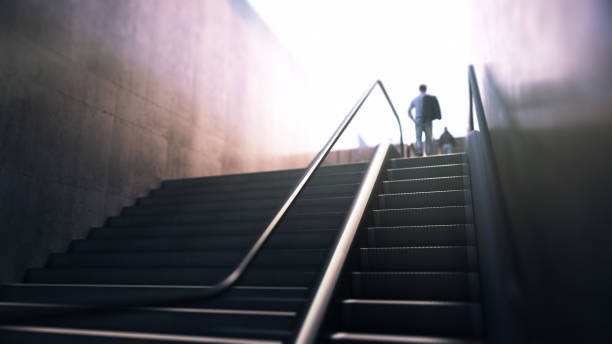 istock People Going Up Escalators Towards the Light, Concept of New Beginnings 2178775460