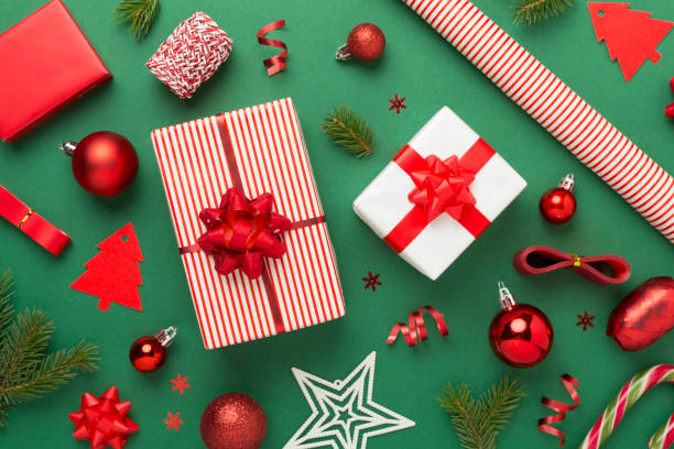 istock Handmade wrapped christmas gift boxes with stuff on color background, top view 2178776089