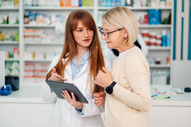 istock Female pharmacist with tablet having consultations with senior woman. 2178779038