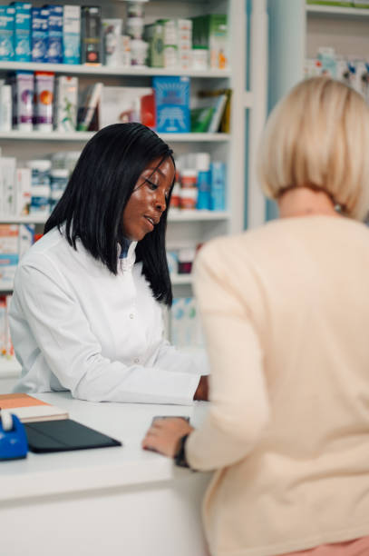istock Diverse pharmacist helping senior woman and selling her medicament. 2178779051