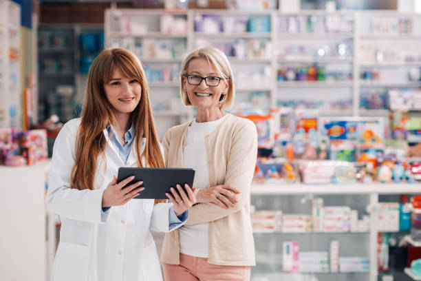 istock Pharmacist showing digital tablet to customer in pharmacy 2178779061