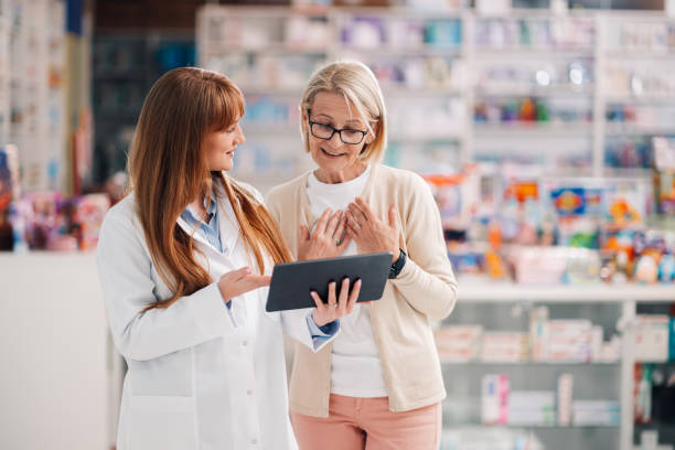 istock Pharmacist showing information on digital tablet to customer in pharmacy 2178779072