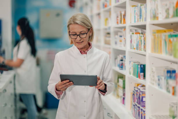 istock Senior female pharmacist using digital tablet, managing inventory in pharmacy 2178779115