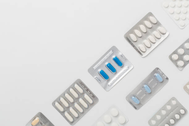 istock Pills in blister packaging on color background, top view 2178779532