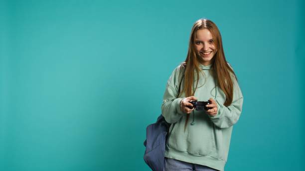 istock Young gamer girl holding controller, focused on finishing game 2178781124