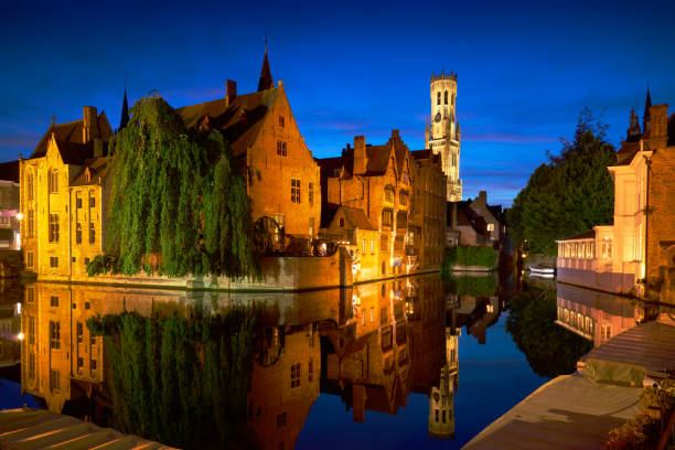 Twilight in the historic city of Bruges, Belgium, with medieval buildings, canals and belfry.