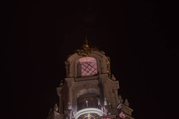 View of top part of bell tower of Lavra in Sergiev Posad illuminated by electric lights on the dark night sky background