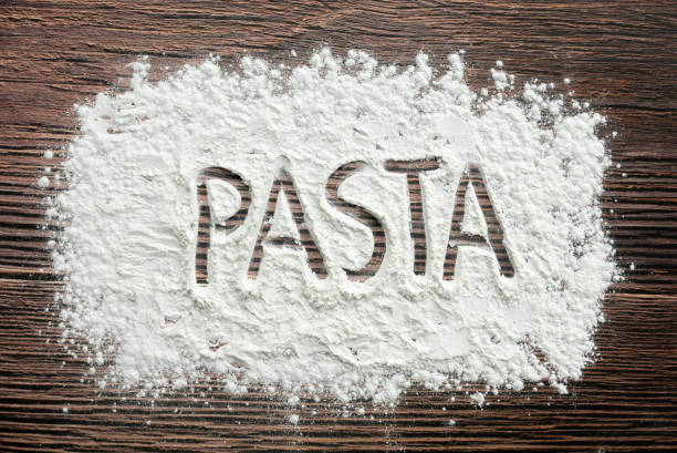 istock Pasta written on a sprinkled flour powder on the table. 2178793596