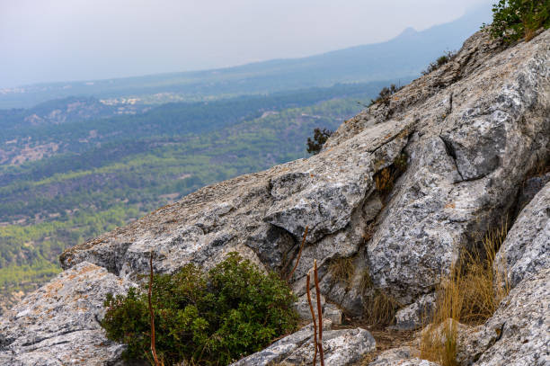 istock Hikers traverse rocky terrain at a mountain peak with breathtaking views during a cloudy day in nature 2178795723