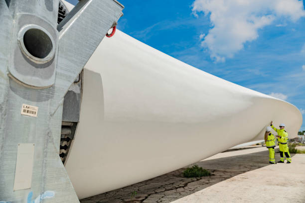 istock Two engineers in high visibility gear use a laptop to work in front of a large wind turbine blade at a construction site. the integration of technology in renewable energy and wind power projects. 2178796085