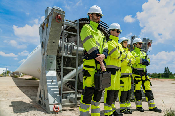 istock A team of engineers stands in front of large wind turbine components at a construction site, ready for installation. The scene highlights teamwork, renewable energy, and wind power technology. 2178796436