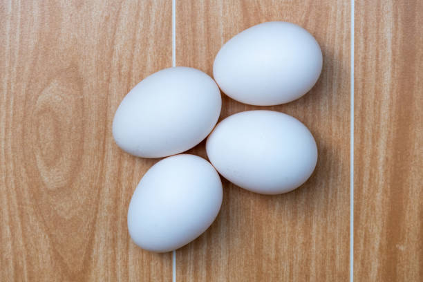 White chicken eggs on a wooden background. These eggs are naturally reared country chicken eggs in the village home of Bangladesh. Top view.