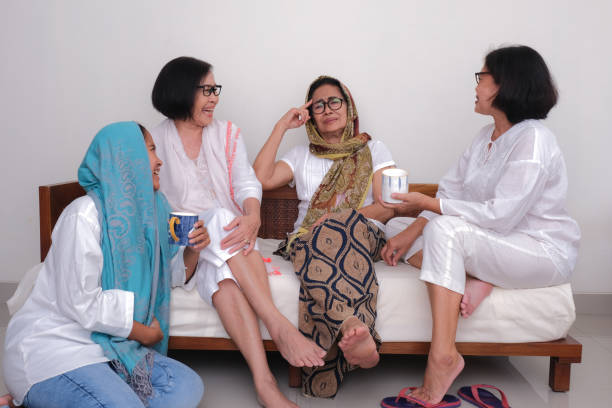 istock Three women sitting with their mom who is telling them funny stories 2178798215