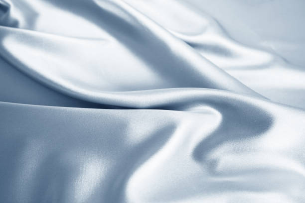Pastel light soft baby pale powder dusty gray silver blue white abstract background. Silk satin fabric. Drapery wave. Winter sky color.