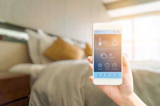 istock mobile phone with smart home app in modern living room 2178800877