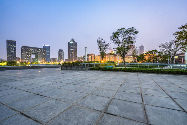 night view of empty brick floor front of modern building