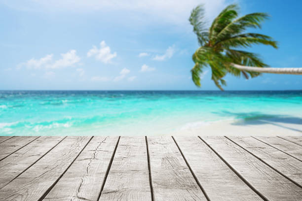 istock Empty wooden table top with beautiful tropical turquoise sea and coconut palm tree background 2178802114