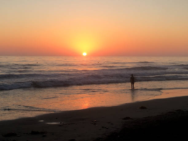 istock Silhouetted Figure in Ocean at Sunset 2178802344