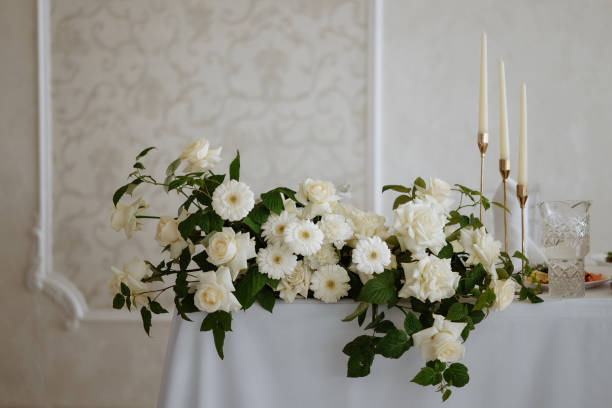 istock A table with a white tablecloth and a vase of white flowers 2178802760
