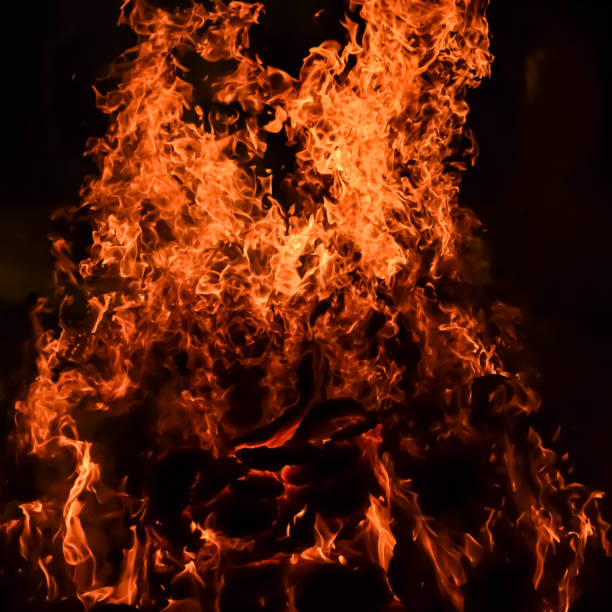 istock Fire flames on black background, Blaze fire flame texture background, Beautifully, the fire is burning, Fire flames with wood and cow dung bonfire 2178802871