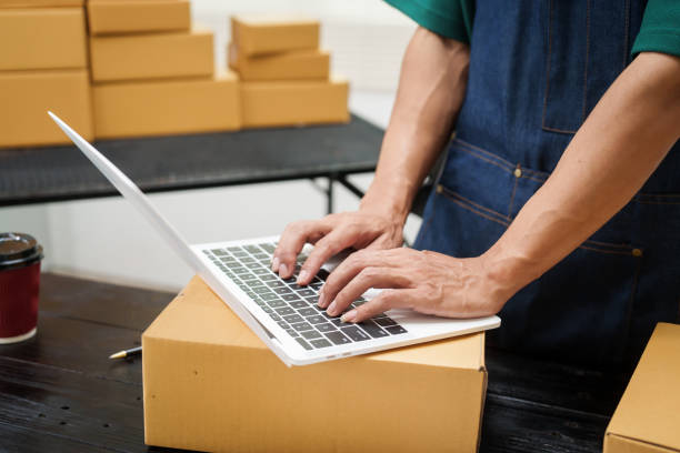 istock A man is working at his desk, preparing parcel boxes for shipment. He checks and packs items carefully, using shockproof materials, and attaches labels before sending them to customers via EMS. 2178803543