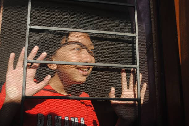 istock Happy teenager looking out through the window. 2178804439
