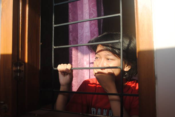 istock Happy teenager looking out through the window. 2178804454