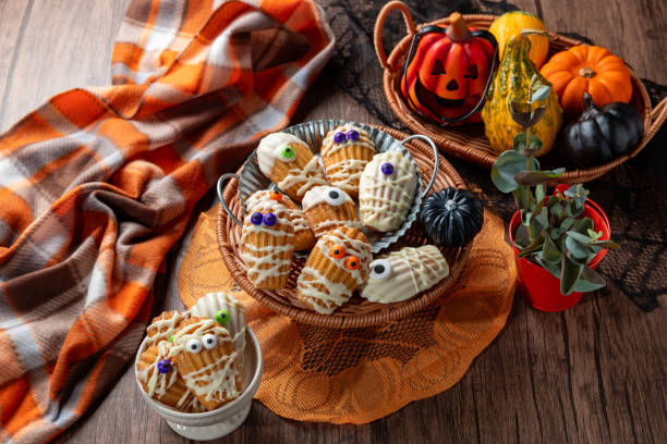 istock White Chocolate Dipped Mummy Madeleines on wooden table. 2178807556