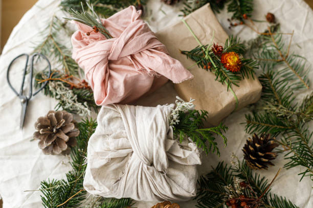 istock Stylish zero waste gifts on rustic table with fir branches, pine cones and dried berries. Merry Christmas! Modern simple wrapped gift boxes with natural ornaments. Sustainable lifestyle 2178808083