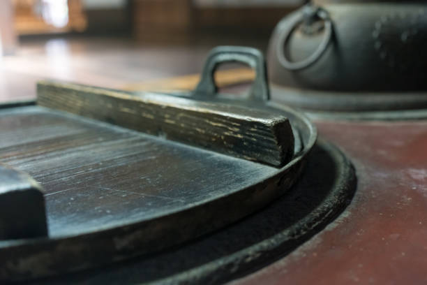 Old iron pot and wooden lid