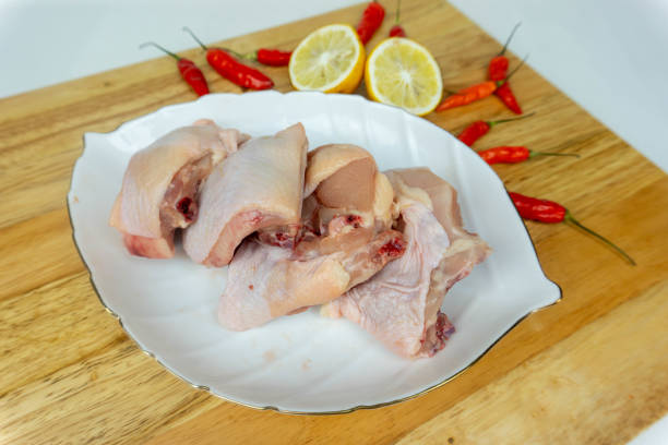 istock Fresh Raw Uncooked Whole Chicken cut without wings and legs on white plate at kitchen cutting wooden board 2178815345