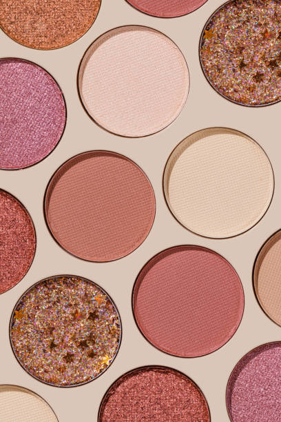 istock Colorful Swatches eyeshadow refills as minimal geometric pattern. Matte and glitter pans red brown pink shade with sun shadows, detail texture, cosmetic, beauty product, makeup, warm color scheme 2178815853