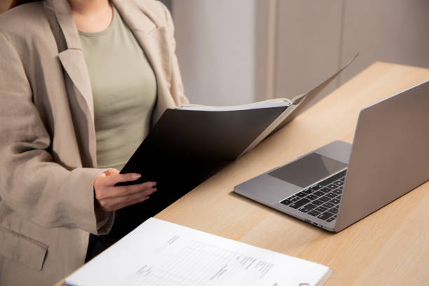 istock Young asian woman sitting looking file documents planning for success in modern office, businesswoman working on desk while laptop on table with confident, employee working on desk, business concept. 2178815943