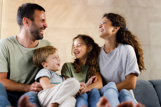 istock Cheerful family talking on sofa at home. 2178816857