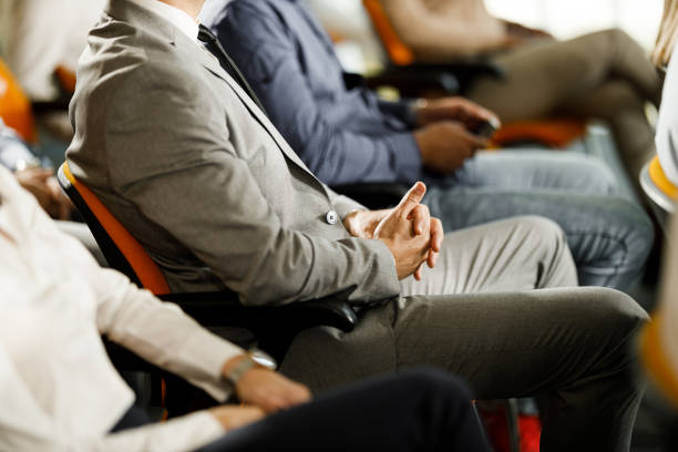 Close up of unrecognizable businessman with his hands cupped on a seminar in the office.